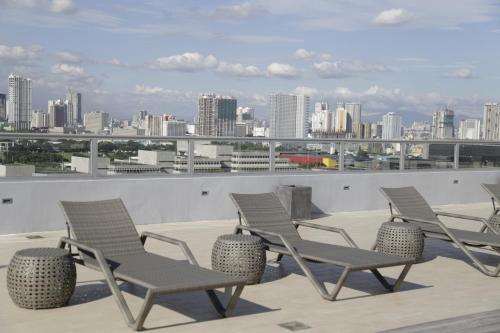 a group of chairs sitting on top of a roof at TRYP by Wyndham Mall of Asia Manila in Manila