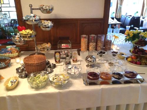a table with a buffet of food on it at Deutsches Haus Munster in Munster im Heidekreis