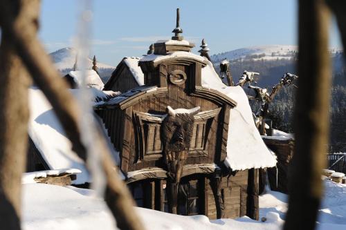 a building covered in snow with an eagle on it at Apartmán Tatran A 12 in Donovaly