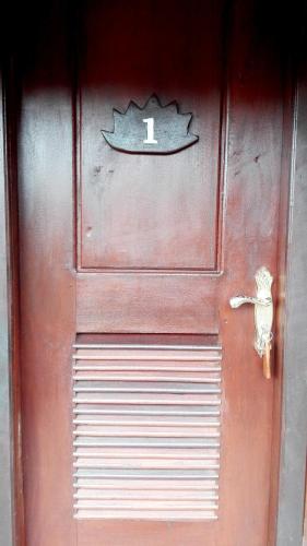 a red door with a fish sign on it at Greenhouse Retreat in Sen Monorom