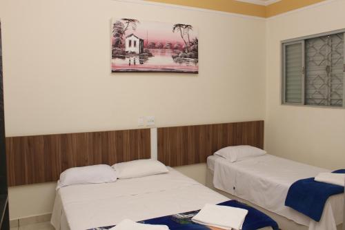 En eller flere senge i et værelse på Hotel São Caetano