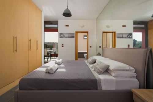 a bedroom with a large bed with towels on it at Almond Villa in Rhodes Town