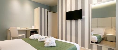 a hotel room with a bed with towels on it at Navigliotel 19 - Rooms & Suites in Milan