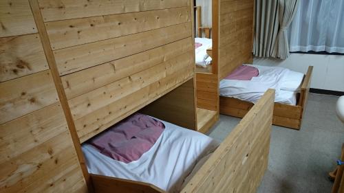Un pat sau paturi într-o cameră la Weekly Mansion Ise No.6