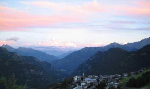 a view of a mountain valley with a city and mountains at Hotel Maisonnette in Torgnon