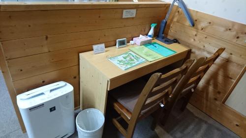 a small wooden desk with a table and chairs at Weekly Mansion Ise No.6 in Ise