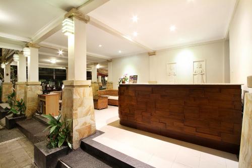 a lobby with a bar in a building at The Niche Bali in Legian