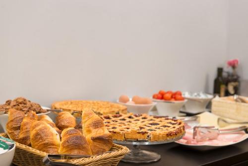 a table topped with baskets of bread and other foods at Residenza Flaminio Gaio in Rome