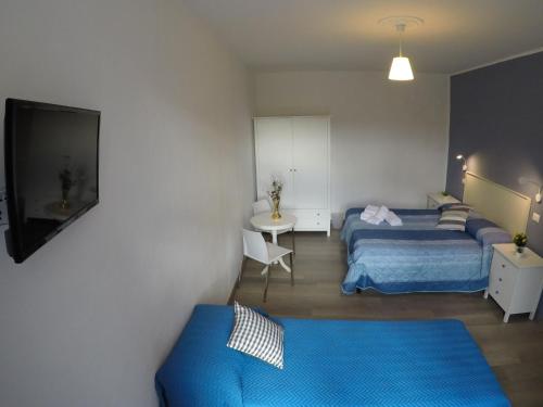 Una habitación de hotel con dos camas y un televisor. en I Vicini della Cattedrale, en Palermo