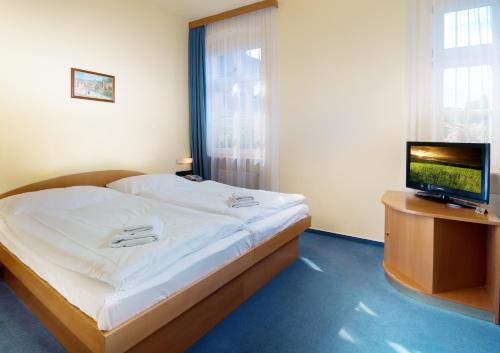 Un ou plusieurs lits dans un hébergement de l'établissement Hotel Ruze