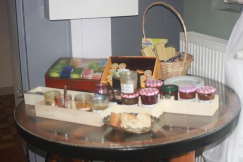 a glass table with food on top of it at Logis Hôtel Restaurant de la Dore in Vertolaye