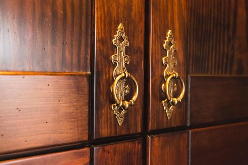 a wooden door with gold handles on a wooden wall at Guest House Valentincic in Nova Gorica