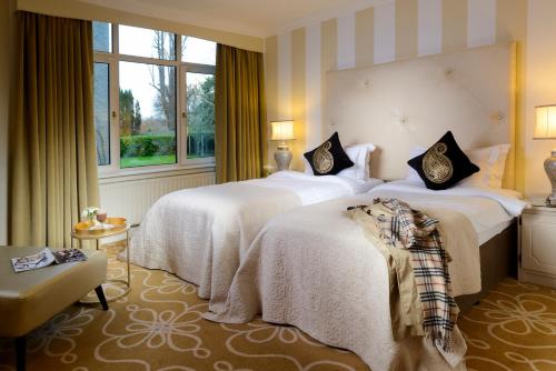 a hotel room with two beds and a window at Great Southern Killarney in Killarney