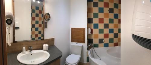 a bathroom with a sink and a toilet and a shower at Hôtel Barbier des Bois in Bruailles