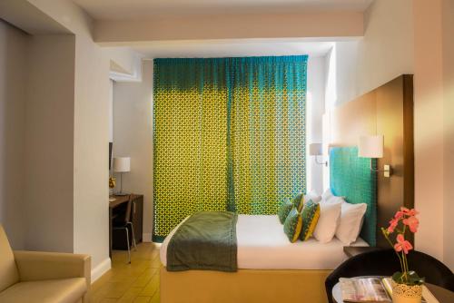 a bedroom with a bed and a green curtain at Residenza Flaminio Gaio in Rome