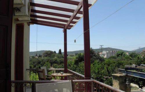 a balcony with a table and chairs and a view at Manganos Apartments in Kambos