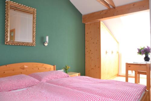 Schlafzimmer mit einem Bett mit einem Spiegel und einem Tisch in der Unterkunft Haus H.O.F. in Ramsau am Dachstein