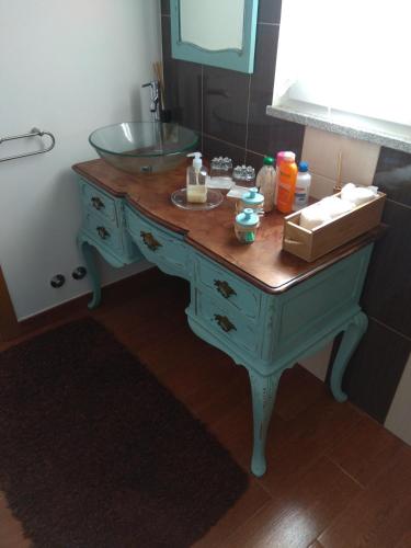 a bathroom vanity with a sink and a mirror at Quarto privado Alentejo Litoral in Grândola