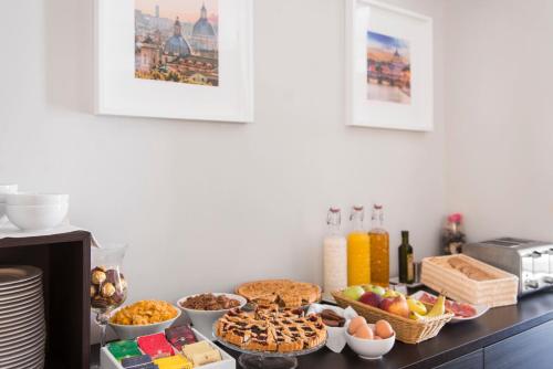 a table topped with lots of different types of food at Residenza Flaminio Gaio in Rome