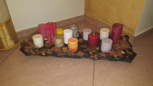 a group of candles on a tray on the floor at Sveciu namelis in Šiauliai