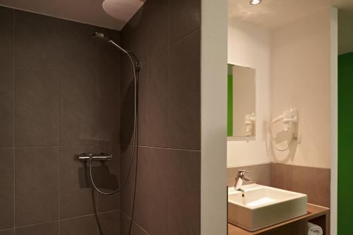 a bathroom with a shower and a sink at a2 HOTELS Plochingen in Plochingen