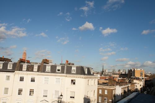 a view of a white building in a city at Best Western Victoria Palace in London