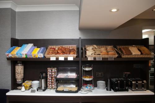 a shelf filled with different types of bread and pastries at Best Western Victoria Palace in London