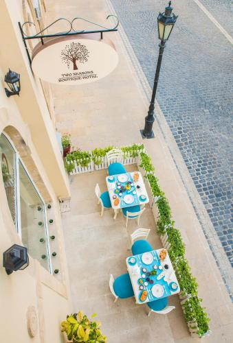 an overhead view of tables and chairs and a street light at Two Seasons Boutique Hotel Baku in Baku