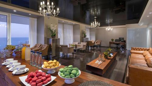 a room with a table with bowls of fruit on it at Island Luxurious Suites Hotel and Spa in Netanya
