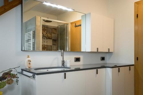 a bathroom with a sink and a mirror at Villa Sissi in Laives