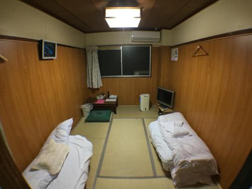 a hospital room with two beds and a chalk board at Kenroku Haitsu 101 in Kanazawa