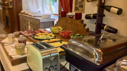 a kitchen with a counter with a toaster and some food at Ezüstfenyő Hotel in Telkibánya