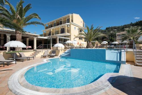 a large swimming pool in front of a hotel at Sea Breeze Hotel & Apartments in Agios Gordios