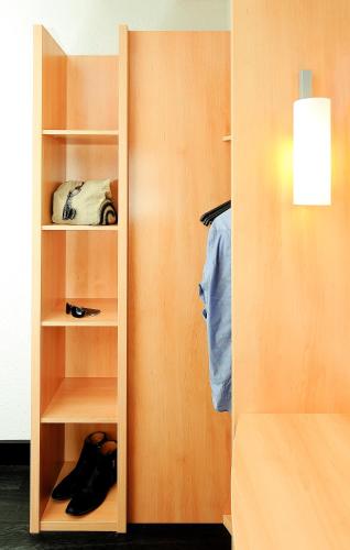 a closet with a door open with shoes in it at ibis Antofagasta in Antofagasta