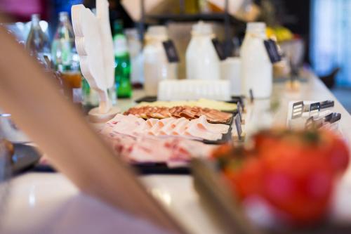 a table topped with a plate of food on a counter at Ibis Barcelona Castelldefels in Castelldefels