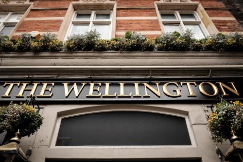a building with a sign on the front of it at The Wellington Hotel in London