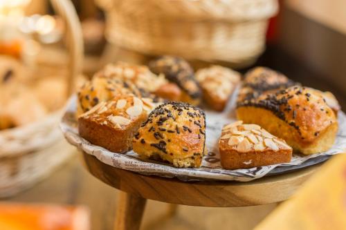 a bunch of pastries on a plate on a table at Ibis Barcelona Castelldefels in Castelldefels