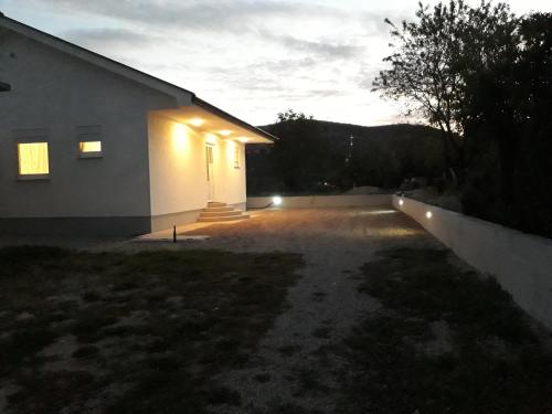 a house with lights on the side of it at Little Mostar house in Mostar