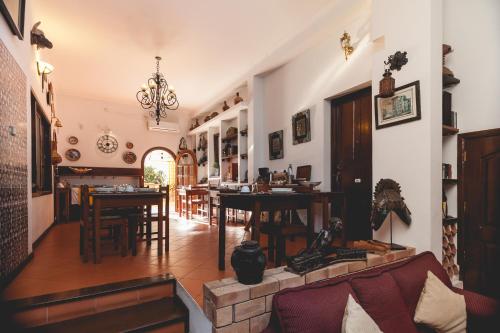 a living room and dining room with a table and chairs at Palmeiras Guest House Maputo in Maputo
