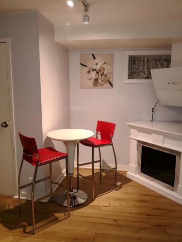 a table and four chairs in a room with a fireplace at Rideau Inn in Ottawa