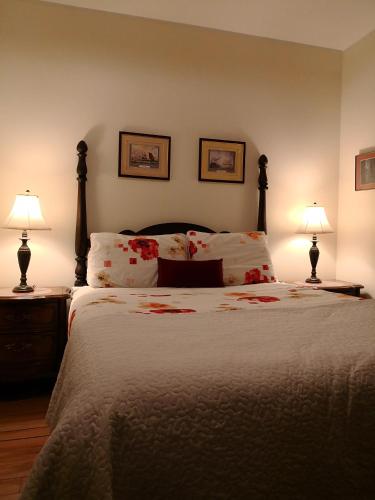 a bedroom with a large bed with two lamps at Rideau Inn in Ottawa