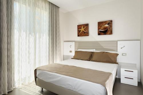 Postel nebo postele na pokoji v ubytování Hotel & Residence Cavalluccio Marino