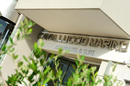 a sign on the side of a building at Hotel & Residence Cavalluccio Marino in Rimini