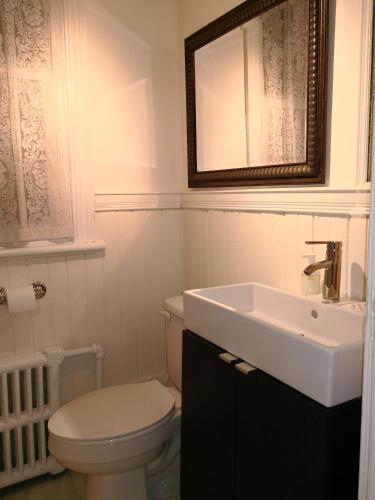 a bathroom with a white toilet and a sink at Rideau Inn in Ottawa