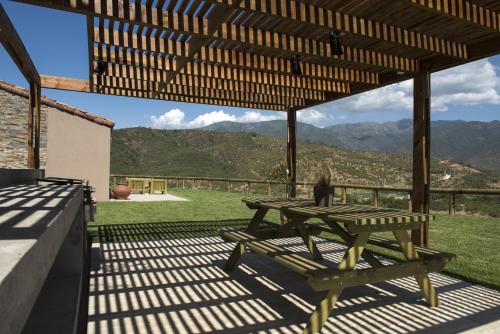 a picnic table on a patio with a view of the mountains at Villas Toscanas in Limache