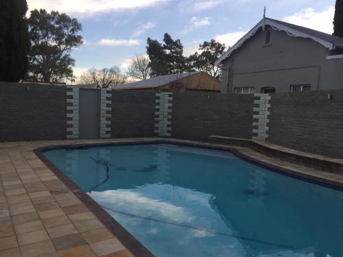 a swimming pool in front of a fence at Tranquil House B&B @ 1 College Ave in Queenstown