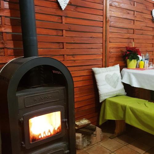 a wood stove in a room with a table at Zsigmond Vendégház in Villány