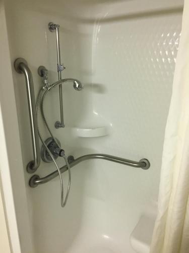 a towel rack in a bathroom with a toilet at Super 8 by Wyndham College Station in College Station
