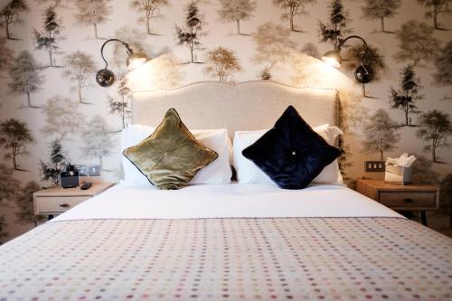 a bedroom with a bed with two pillows on it at The White Hart Hotel in Kingston upon Thames