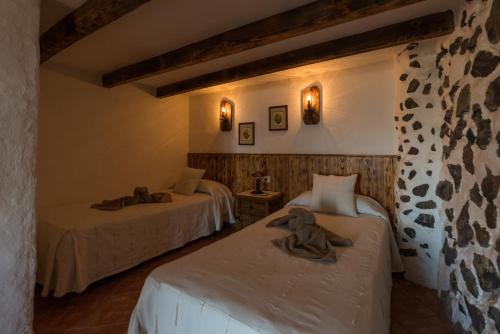 a room with two beds with towels on them at La Brujita in Frontera